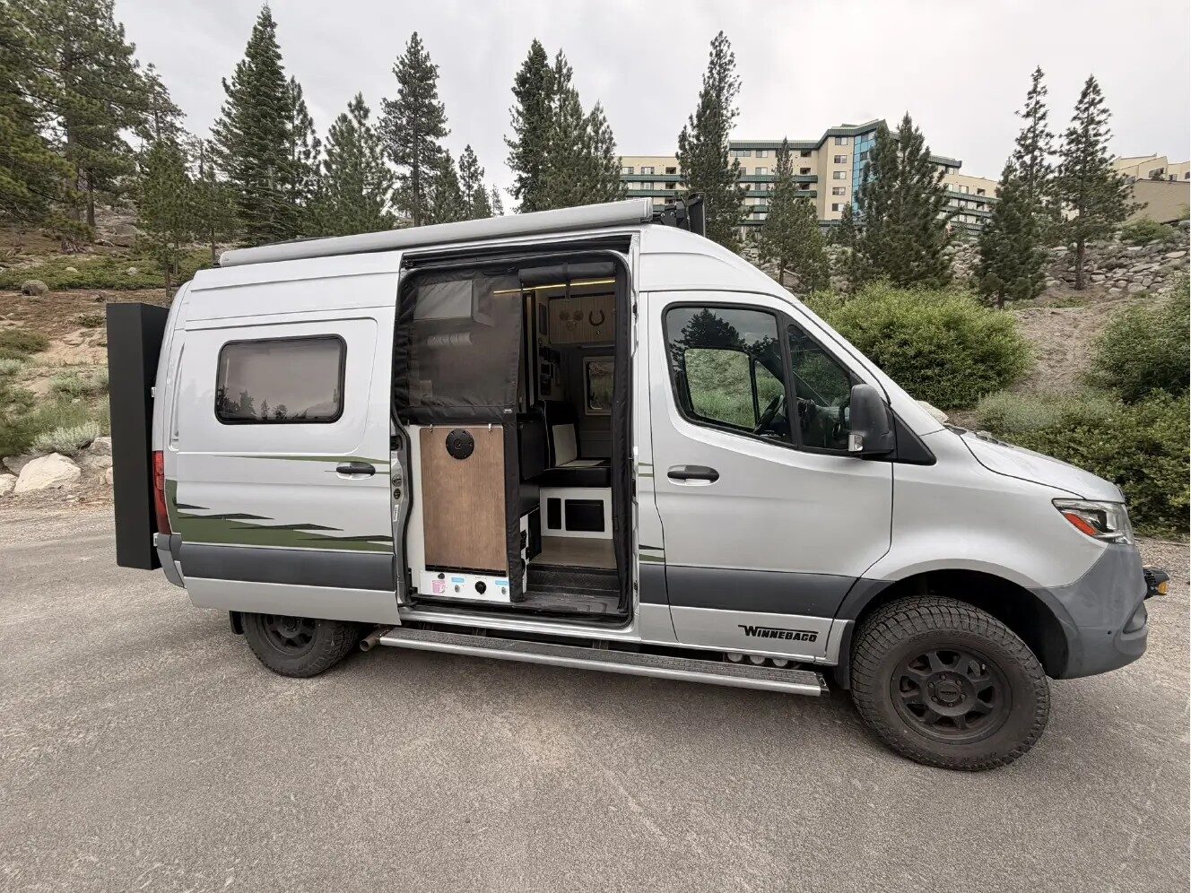 2019 Winnebago Revel parked in the mountains, side door open