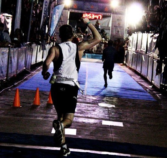 Crossing the Ironman Cozumel finish line at night, 12:53:47 on the clock